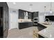 Modern kitchen boasting dark cabinetry, stainless steel appliances, and a stylish backsplash at 3171 Biccari Ave, Henderson, NV 89044