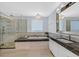 Luxury main bathroom with soaking tub, walk-in glass shower, marble countertop vanity, and modern fixtures at 3171 Biccari Ave, Henderson, NV 89044