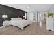 Main bedroom featuring wood-style floors, neutral colors, stylish black accent wall, and natural light at 3171 Biccari Ave, Henderson, NV 89044