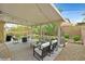 Inviting covered patio with comfortable seating and manicured landscaping at 3171 Biccari Ave, Henderson, NV 89044