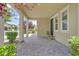 Inviting covered porch area with brick pavers, offering a comfortable outdoor seating space at 3171 Biccari Ave, Henderson, NV 89044