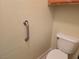 Small half bathroom showing toilet and handrail at 3261 Winery Rd, Pahrump, NV 89048