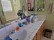 Bathroom with a double sink vanity, tile counters and a mirror at 3261 Winery Rd, Pahrump, NV 89048