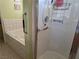 Bathroom featuring a shower, bathtub, grab bars and tiled walls at 3261 Winery Rd, Pahrump, NV 89048