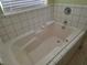 Clean, tiled bathtub and shower with neutral tile at 3261 Winery Rd, Pahrump, NV 89048