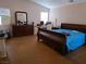 Bedroom with light pink walls, laminate floors, desk, dresser, and window at 3261 Winery Rd, Pahrump, NV 89048