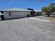 Charming single-story home featuring a gravel front yard, walkway, and neutral exterior paint at 3261 Winery Rd, Pahrump, NV 89048