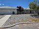 Charming single-story home with decorative rock landscaping and mature trees at 3261 Winery Rd, Pahrump, NV 89048
