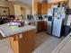 Kitchen with tile counters, stainless steel appliances, and wood cabinetry at 3261 Winery Rd, Pahrump, NV 89048