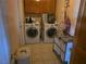 Functional laundry room features washer, dryer, and storage at 3261 Winery Rd, Pahrump, NV 89048