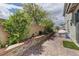 Charming backyard with low brick wall and lush plants at 3707 Paseo De Paz Ave, Las Vegas, NV 89115