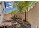 Backyard patio area with greenery along the brick retaining wall at 3707 Paseo De Paz Ave, Las Vegas, NV 89115