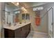 This modern bathroom offers dual sinks, a large mirror, and natural light at 3707 Paseo De Paz Ave, Las Vegas, NV 89115