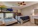 Cozy bedroom featuring a bunk bed, double bed, ceiling fan, and a vanity with makeup mirror at 3707 Paseo De Paz Ave, Las Vegas, NV 89115