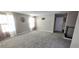 Spacious bonus room with plush carpeting, neutral walls, and large windows for natural light at 3707 Paseo De Paz Ave, Las Vegas, NV 89115