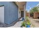 Inviting front entrance with a covered porch, brick pathway, and potted plants leading to the front door at 3707 Paseo De Paz Ave, Las Vegas, NV 89115