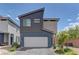 Modern two-story home featuring a two-car garage, contemporary siding, and well-maintained landscaping at 3707 Paseo De Paz Ave, Las Vegas, NV 89115