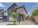 Contemporary two-story home with a two-car garage, side yard landscaping, and fenced-in entry at 3707 Paseo De Paz Ave, Las Vegas, NV 89115