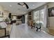 Open-concept living area with lots of natural light, ceiling fan and neutral tile flooring at 3707 Paseo De Paz Ave, Las Vegas, NV 89115