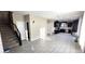Spacious living room showcases sleek tile flooring and an open layout, connecting to the kitchen at 3707 Paseo De Paz Ave, Las Vegas, NV 89115
