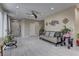Bright and airy living room featuring neutral decor, stylish light fixture, and modern tile flooring at 3707 Paseo De Paz Ave, Las Vegas, NV 89115