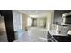 Bright living space with modern flooring and a seamless connection to the kitchen area at 3707 Paseo De Paz Ave, Las Vegas, NV 89115