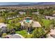 Community aerial view shows a sparkling pool, lush green spaces, and well-maintained homes with beautiful mountain scenery at 4042 Keefe Falls Ct, North Las Vegas, NV 89085