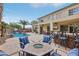 Inviting backyard with outdoor seating, fire pit, built-in bar, and a view of the pool and upper balcony at 4042 Keefe Falls Ct, North Las Vegas, NV 89085