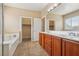 The bathroom features dual sinks, a bathtub, and a walk-in closet at 4042 Keefe Falls Ct, North Las Vegas, NV 89085