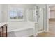 Bathroom featuring soaking tub, glass enclosed shower, and tiled floors at 4042 Keefe Falls Ct, North Las Vegas, NV 89085