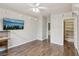 Bedroom featuring wood-look floors, custom shelving, with a mounted TV at 4042 Keefe Falls Ct, North Las Vegas, NV 89085