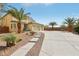 Expansive driveway leads to this home with desert landscaping and decorative pavers at 4042 Keefe Falls Ct, North Las Vegas, NV 89085