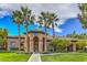 Attractive building entrance with stone accents, mature landscaping, and a well-manicured lawn under a beautiful sky at 4042 Keefe Falls Ct, North Las Vegas, NV 89085
