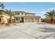 Attractive two-story home with a three-car garage, desert landscaping, and a circular driveway at 4042 Keefe Falls Ct, North Las Vegas, NV 89085