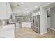 Open kitchen with stainless steel refrigerator, island, and views of the living area at 4042 Keefe Falls Ct, North Las Vegas, NV 89085