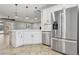 Kitchen island with sink, stainless steel refrigerator, and modern pendant lighting at 4042 Keefe Falls Ct, North Las Vegas, NV 89085