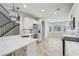 Well-lit kitchen with white cabinetry, stainless steel appliances, and a large island with pendant lighting at 4042 Keefe Falls Ct, North Las Vegas, NV 89085