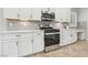 Kitchen with stainless steel oven and microwave with white cabinetry and counters at 4042 Keefe Falls Ct, North Las Vegas, NV 89085