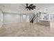 Spacious living room featuring tile floors, modern ceiling fan, and stairs to upper level at 4042 Keefe Falls Ct, North Las Vegas, NV 89085