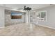 Bright living room with stone accent wall, ceiling fan, and sliding glass doors to the outdoor space at 4042 Keefe Falls Ct, North Las Vegas, NV 89085
