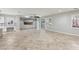 Large living room with tile floors and stone accent wall with built in TV at 4042 Keefe Falls Ct, North Las Vegas, NV 89085