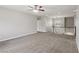 Carpeted loft area with a ceiling fan, staircase, and natural light creating a welcoming space at 4042 Keefe Falls Ct, North Las Vegas, NV 89085