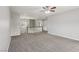 Bright carpeted loft with a ceiling fan and staircase offering flexible living space at 4042 Keefe Falls Ct, North Las Vegas, NV 89085