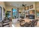 Spacious lounge area with cozy fireplace, comfortable seating, and large windows offering an inviting atmosphere at 4042 Keefe Falls Ct, North Las Vegas, NV 89085