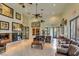 Bright lounge area featuring comfortable leather seating, elegant decor, and a cozy fireplace with views to the kitchen at 4042 Keefe Falls Ct, North Las Vegas, NV 89085