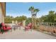 Spacious outdoor patio features wrought iron railing, outdoor seating area and palm trees at 4042 Keefe Falls Ct, North Las Vegas, NV 89085