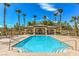 Inviting swimming pool area with lounge chairs, a covered pavilion, and surrounded by lush palm trees under a blue sky at 4042 Keefe Falls Ct, North Las Vegas, NV 89085