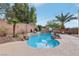 Backyard inground pool features beautiful landscaping and palm trees for an oasis effect at 4042 Keefe Falls Ct, North Las Vegas, NV 89085