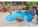Beautiful backyard pool area with decorative rock features, palm trees and cool, refreshing water at 4042 Keefe Falls Ct, North Las Vegas, NV 89085