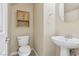 Cozy powder room with a pedestal sink and decorative mirror at 4042 Keefe Falls Ct, North Las Vegas, NV 89085